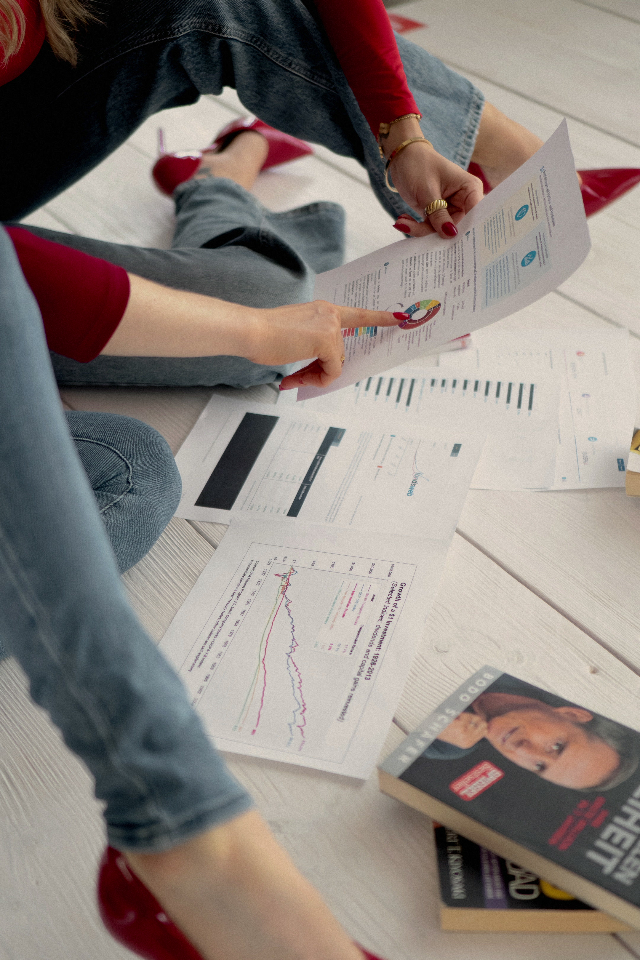 Zwei Frauen gehen gemeinsam Finanzunterlagen und Auswertungen durch